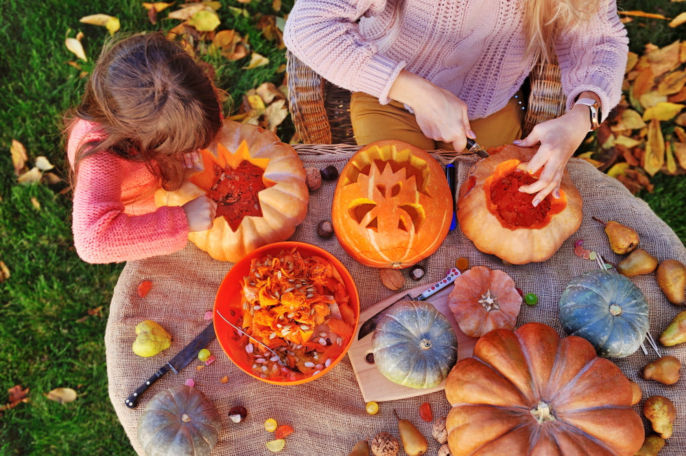 parent and child carving pumpkins