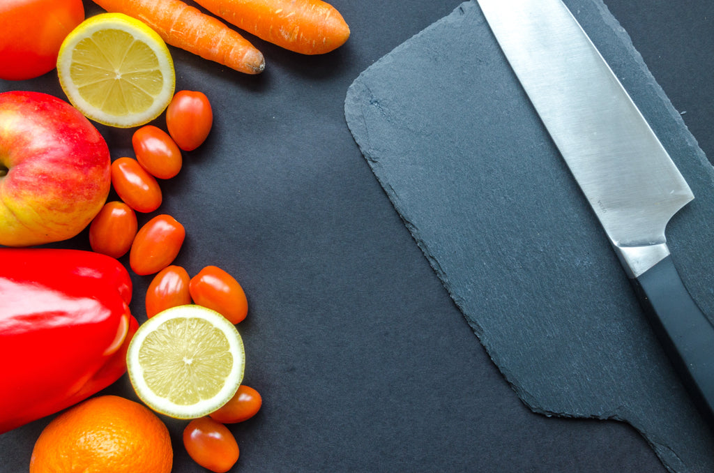 cutting board with vegetables and chef's knife